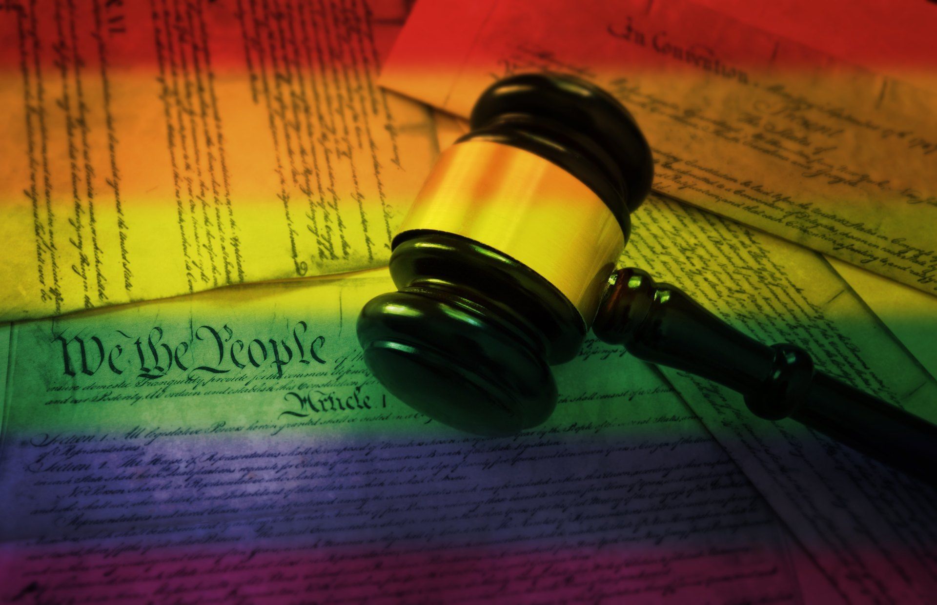 A judge 's gavel is sitting on top of the united states constitution