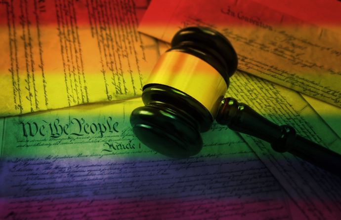 A judge 's gavel is sitting on top of the united states constitution