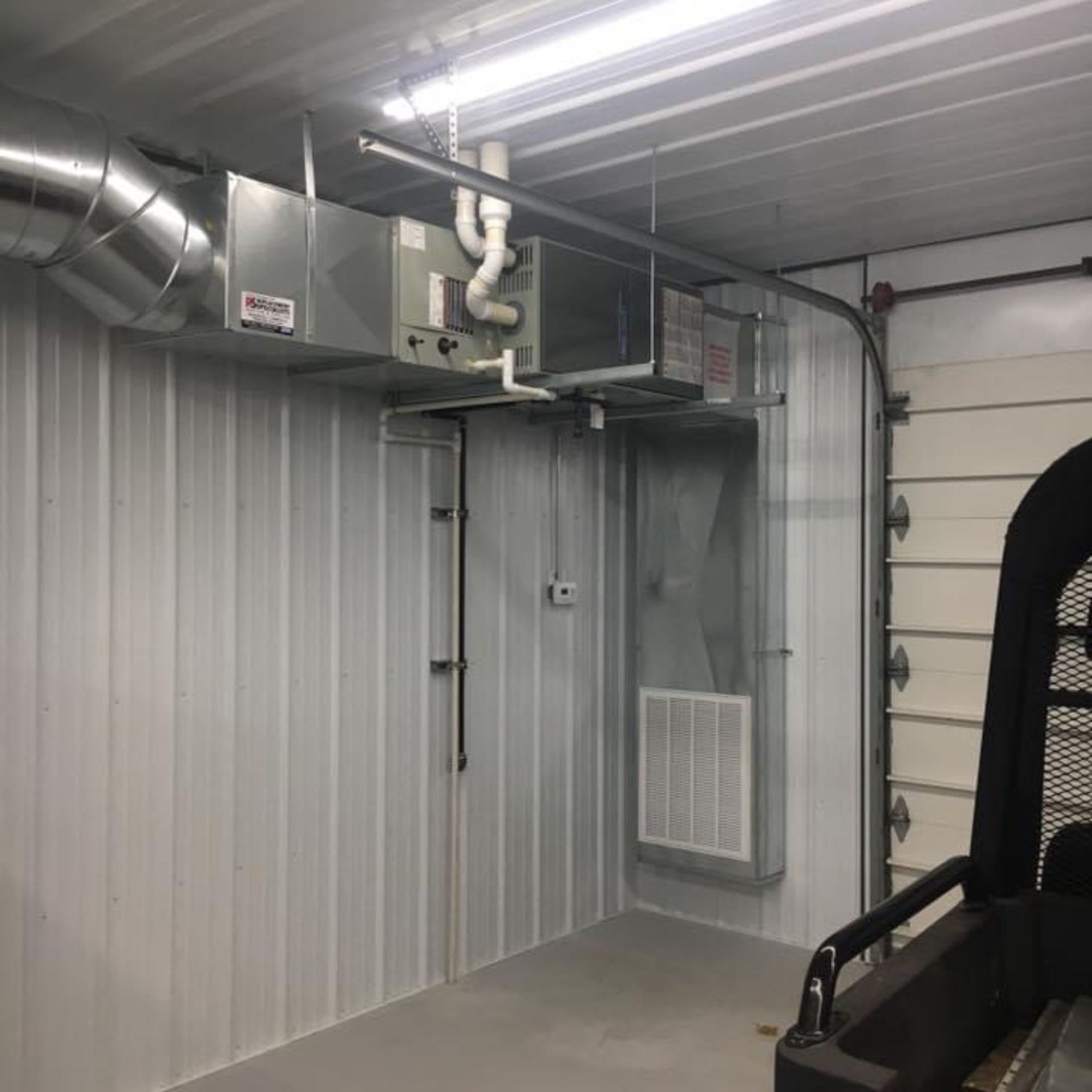 Lake Area Heating and Cooling LLC | A garage with a lot of pipes hanging from the ceiling
