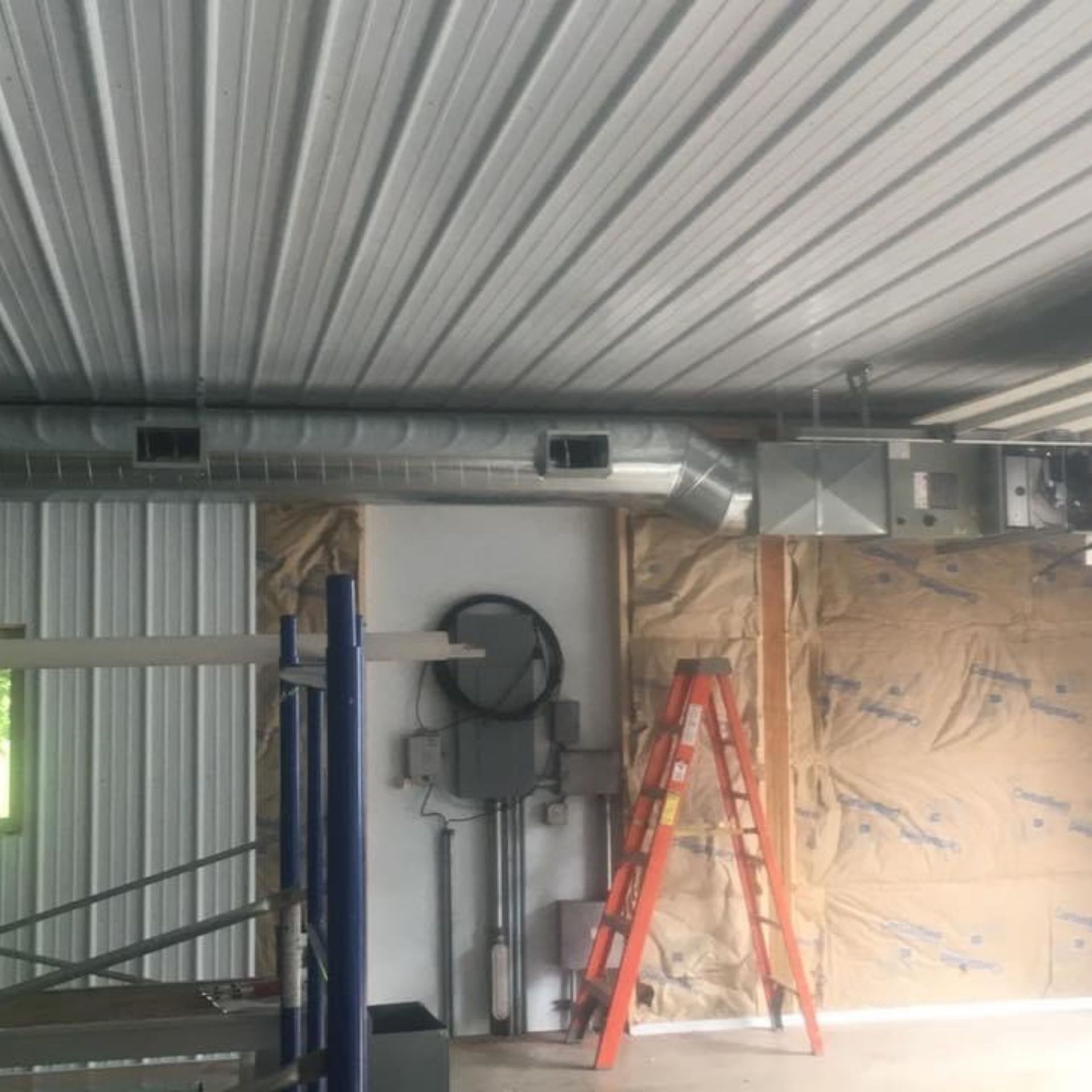 Lake Area Heating and Cooling LLC | There is a ladder in the middle of the room.