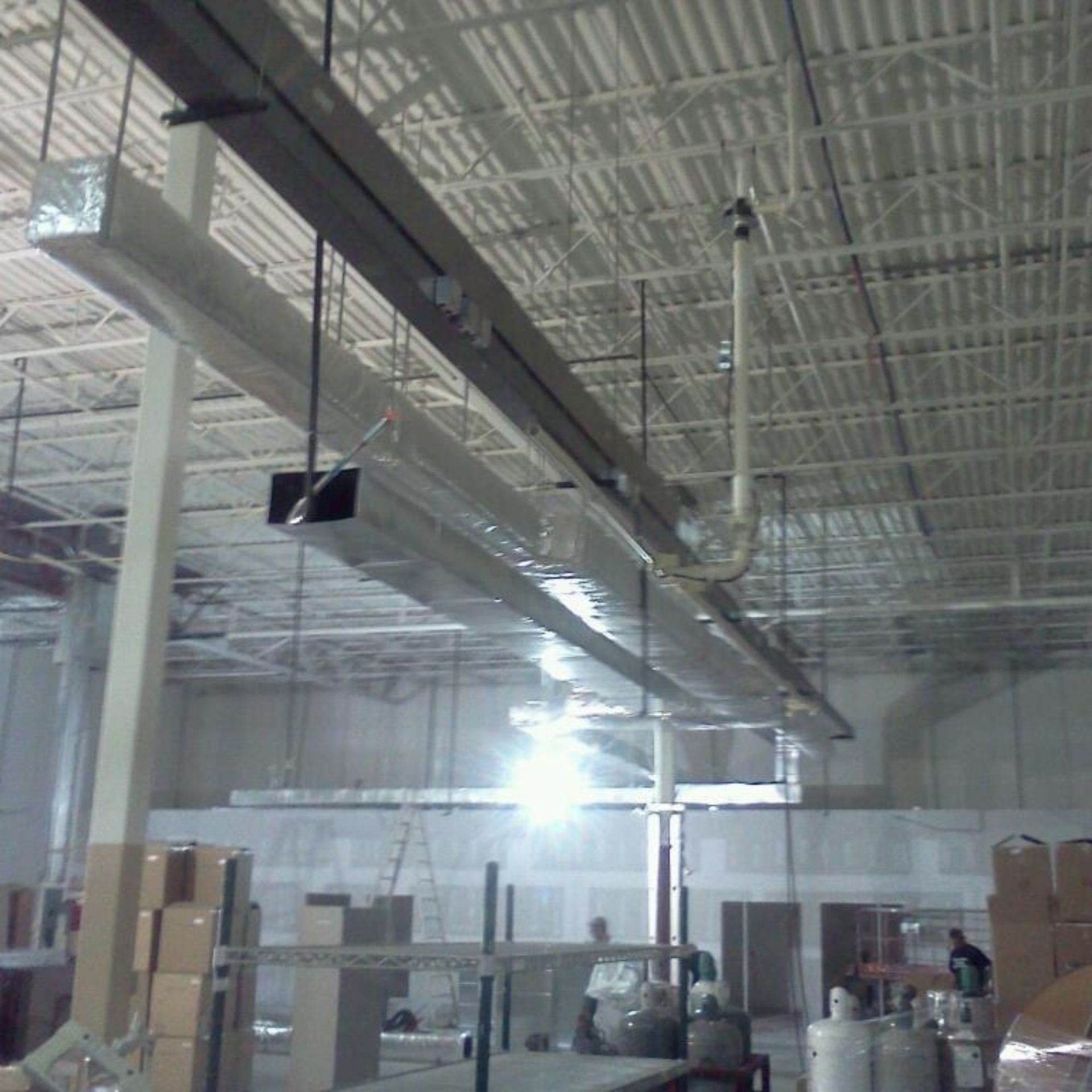 Lake Area Heating and Cooling LLC | A large room with a lot of pipes hanging from the ceiling