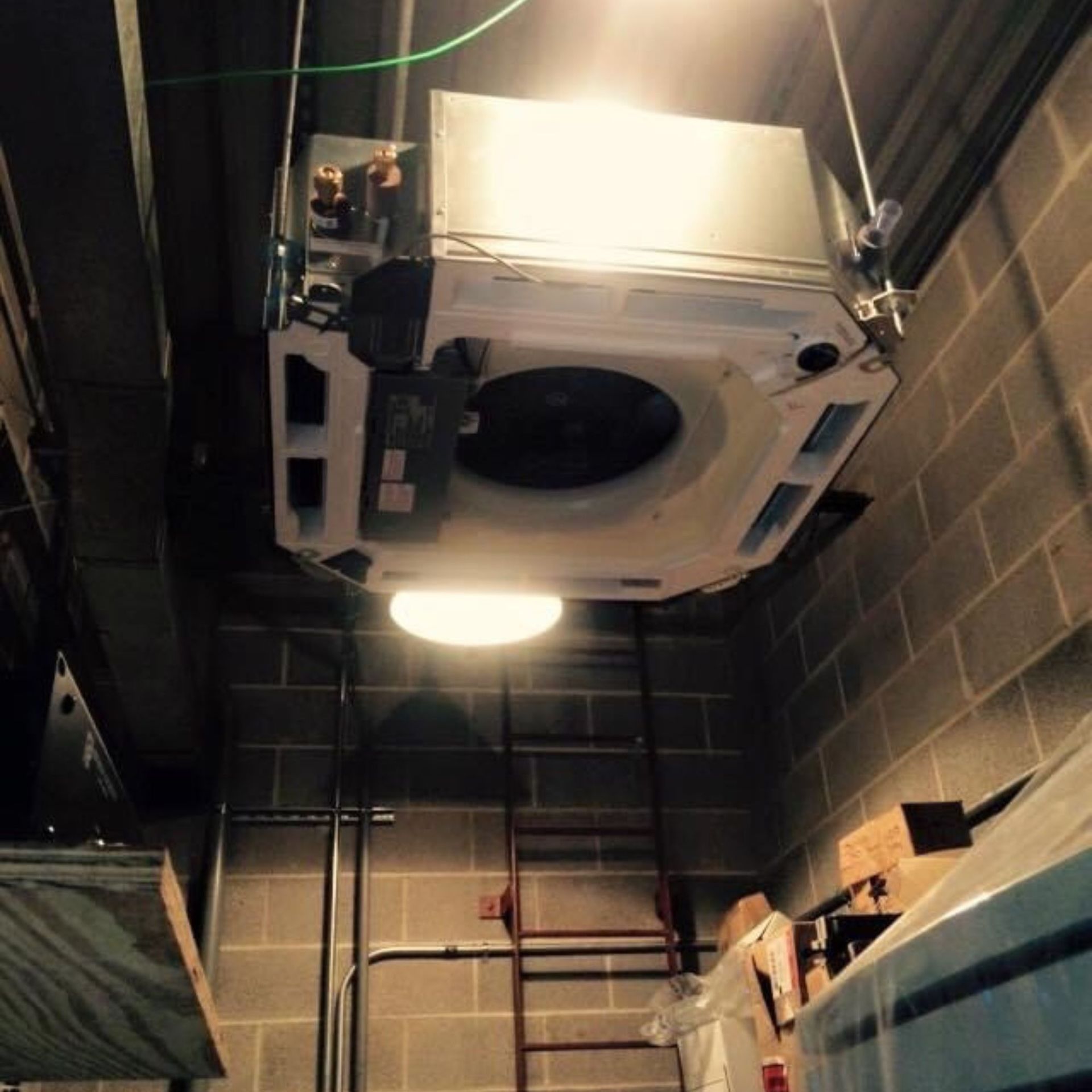 Lake Area Heating and Cooling LLC | A ceiling fan is hanging from the ceiling in a room with a ladder.