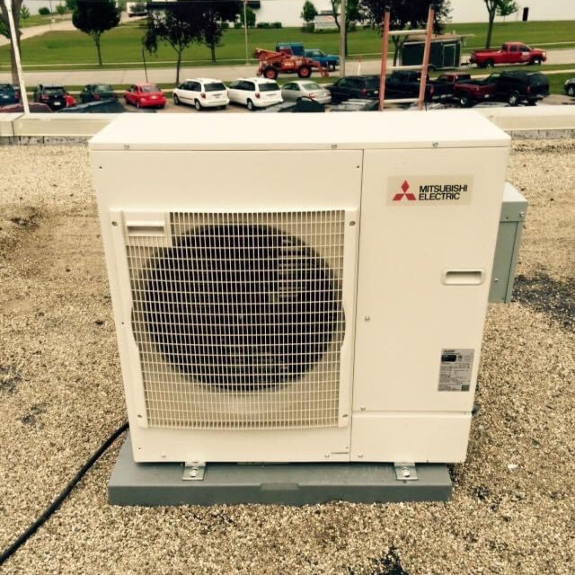 Lake Area Heating and Cooling LLC | A mitsubishi electric air conditioner is sitting on a gravel surface