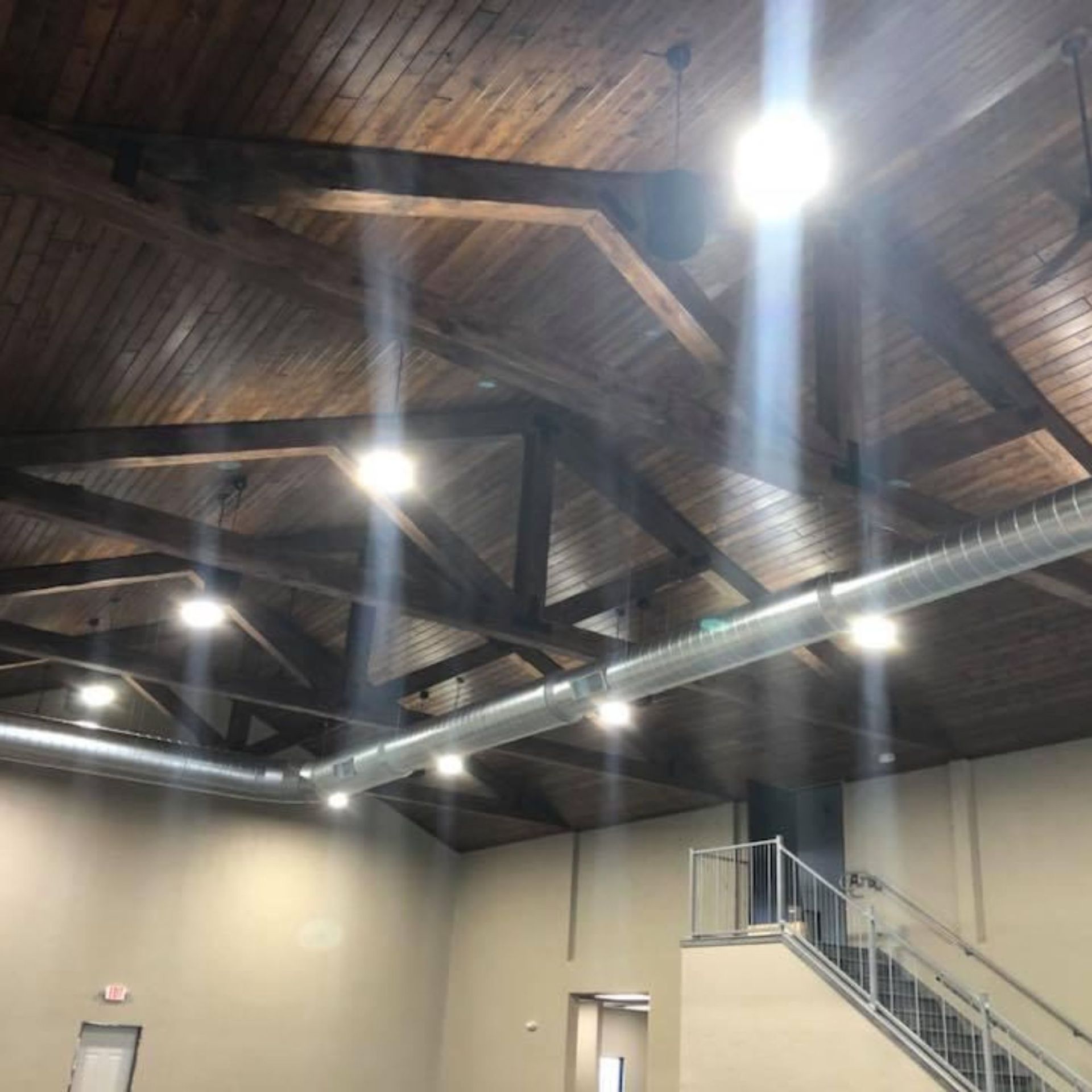 Lake Area Heating and Cooling LLC | A large room with a wooden ceiling and stairs