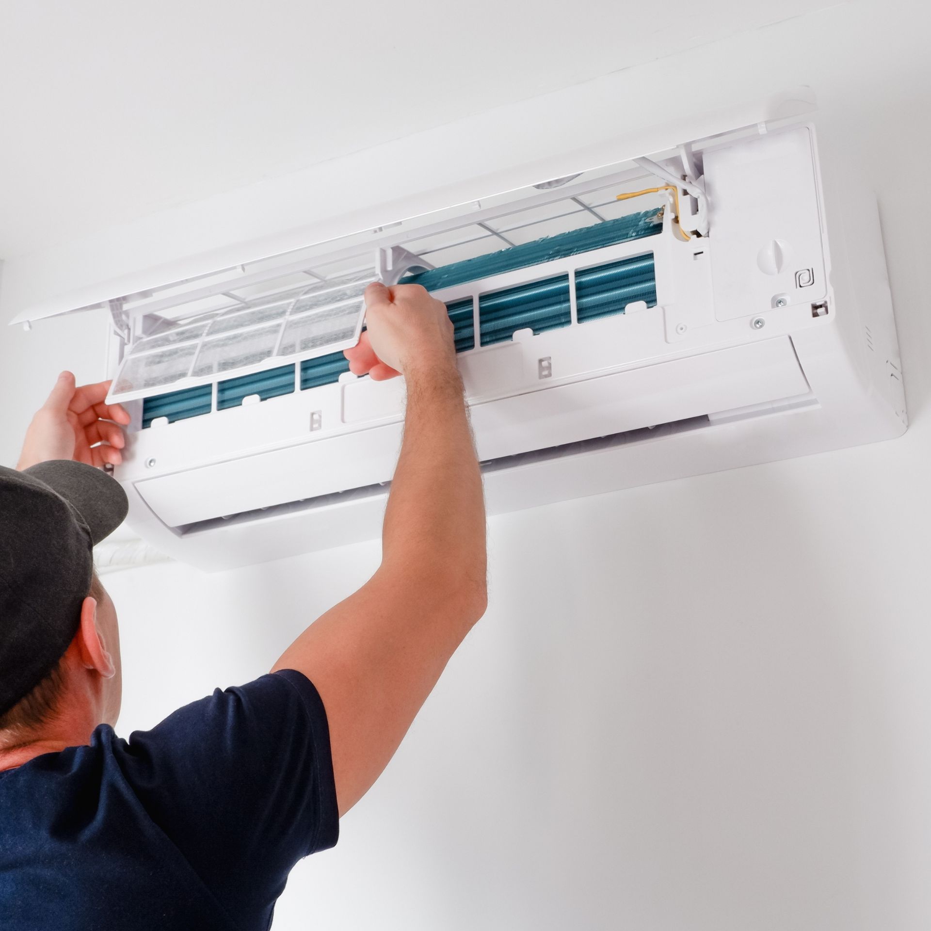 Lake Area Heating and Cooling LLC | A man is working on a wall mounted air conditioner.