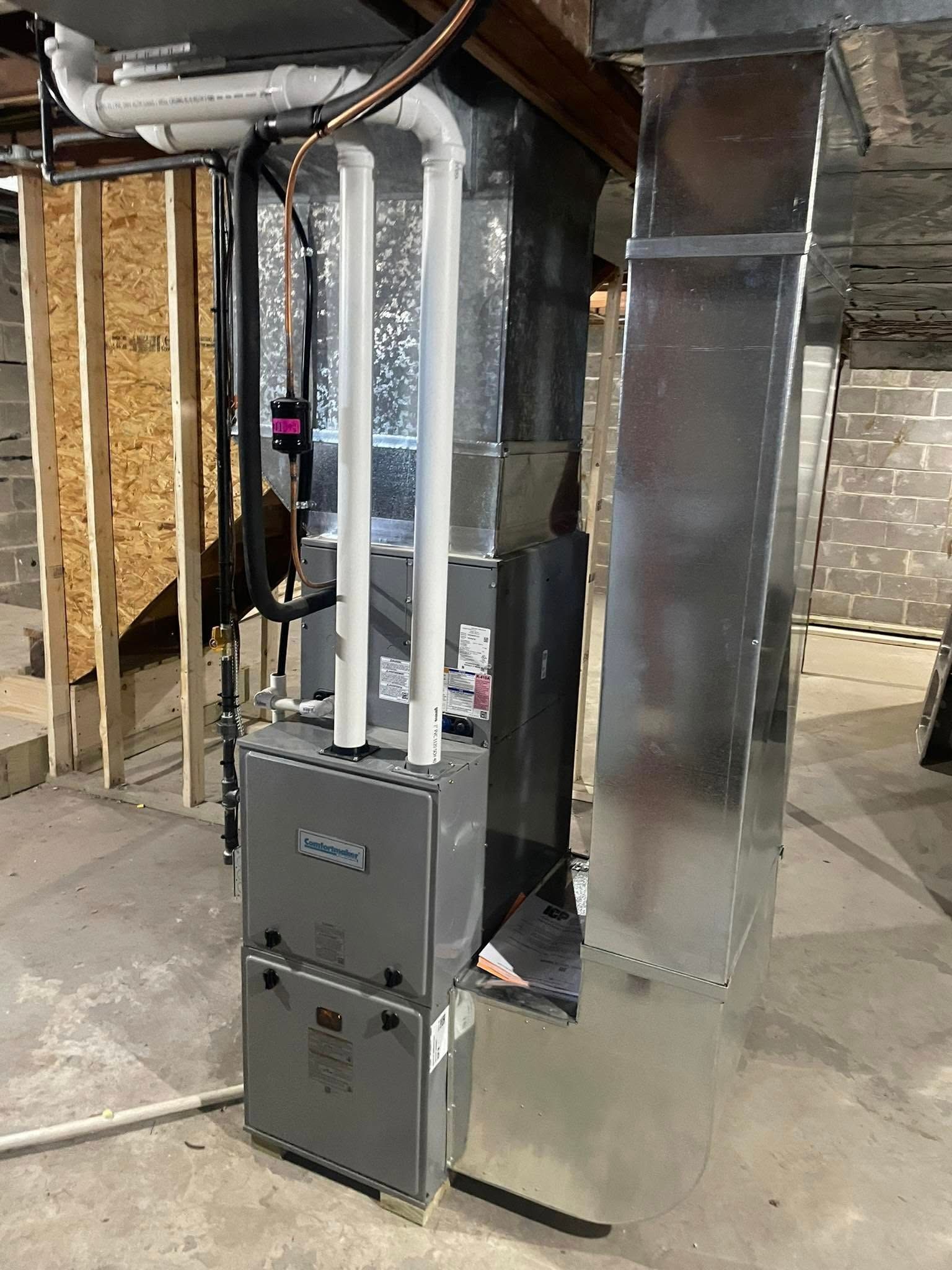 Lake Area Heating and Cooling LLC | A furnace is sitting in a basement under construction.