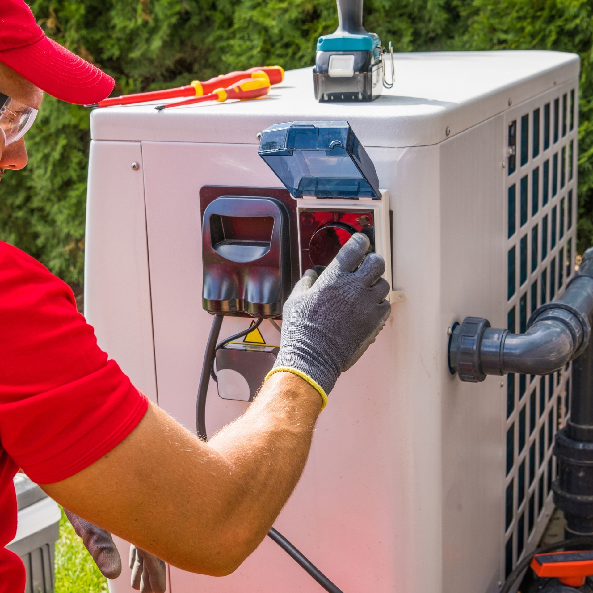 Lake Area Heating and Cooling LLC | A man in a red shirt is working on a machine.