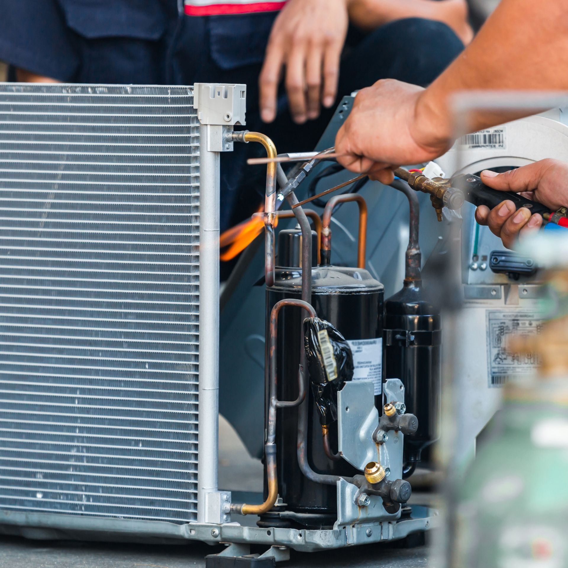 Lake Area Heating and Cooling LLC | A man in a red shirt is working on a machine.