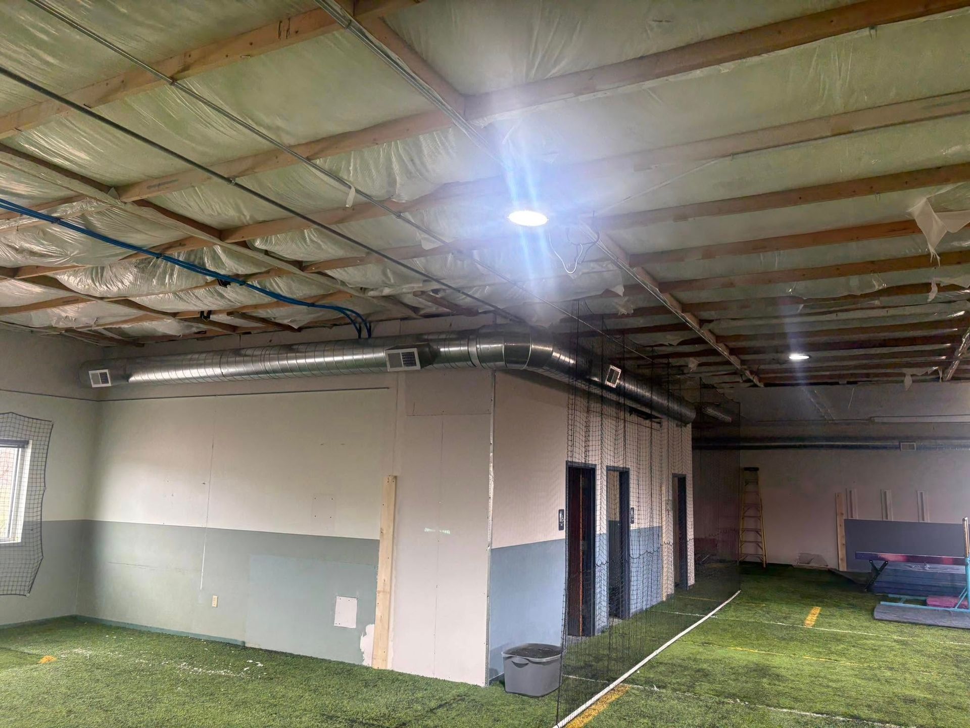 Lake Area Heating and Cooling LLC | A large room with a lot of windows and a ceiling that is covered in insulation.