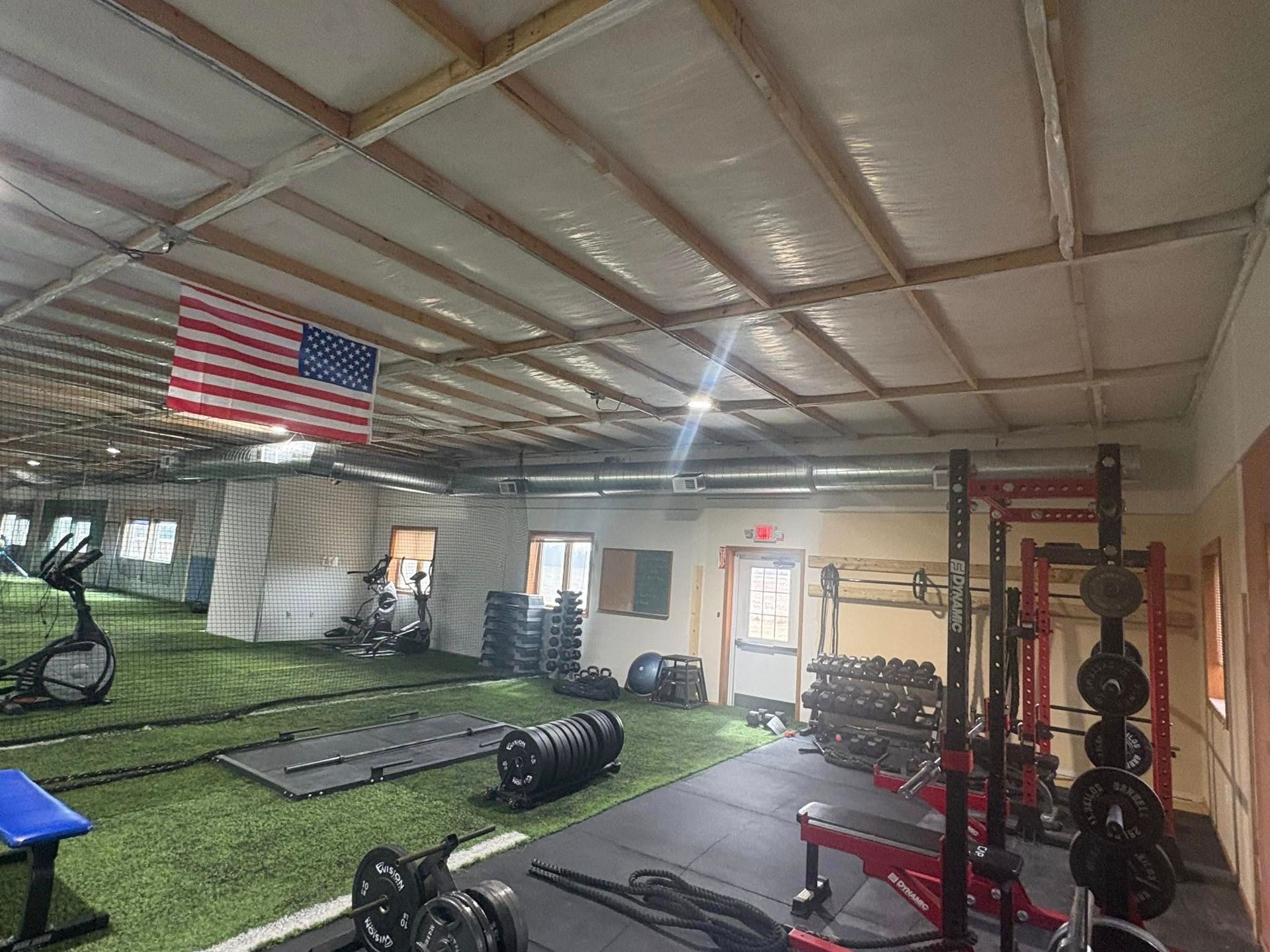 Lake Area Heating and Cooling LLC | A gym with a large american flag hanging from the ceiling.