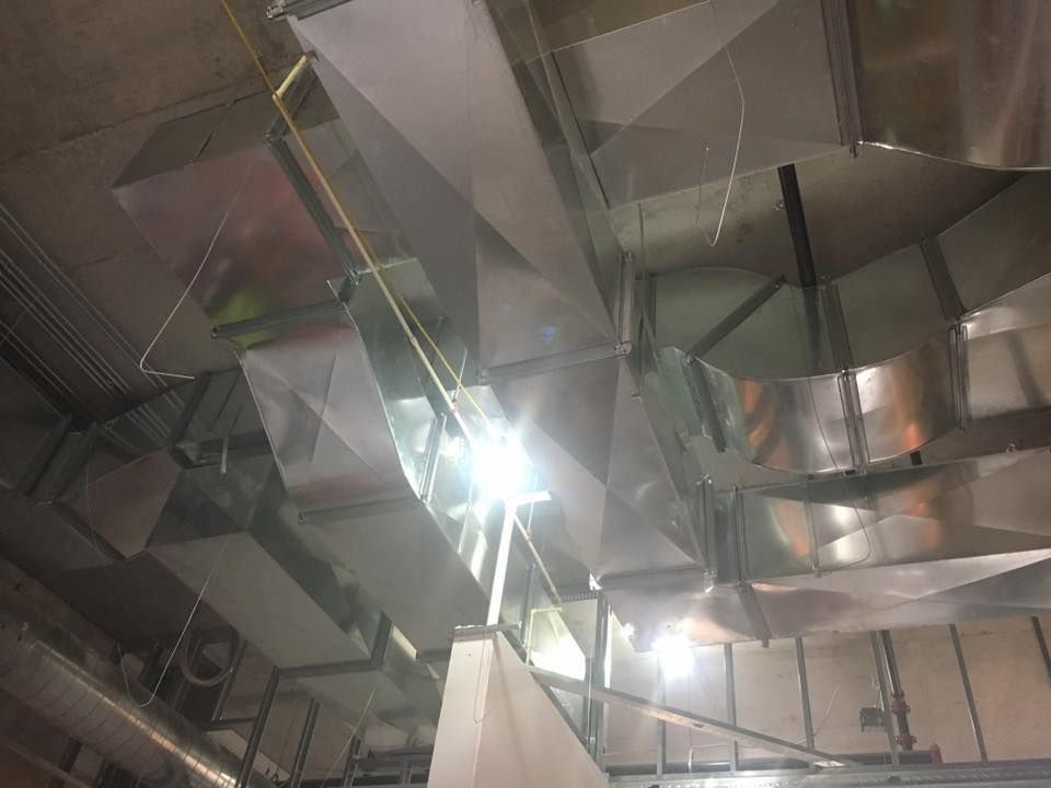 Lake Area Heating and Cooling LLC | A ceiling with a lot of metal pipes hanging from it.