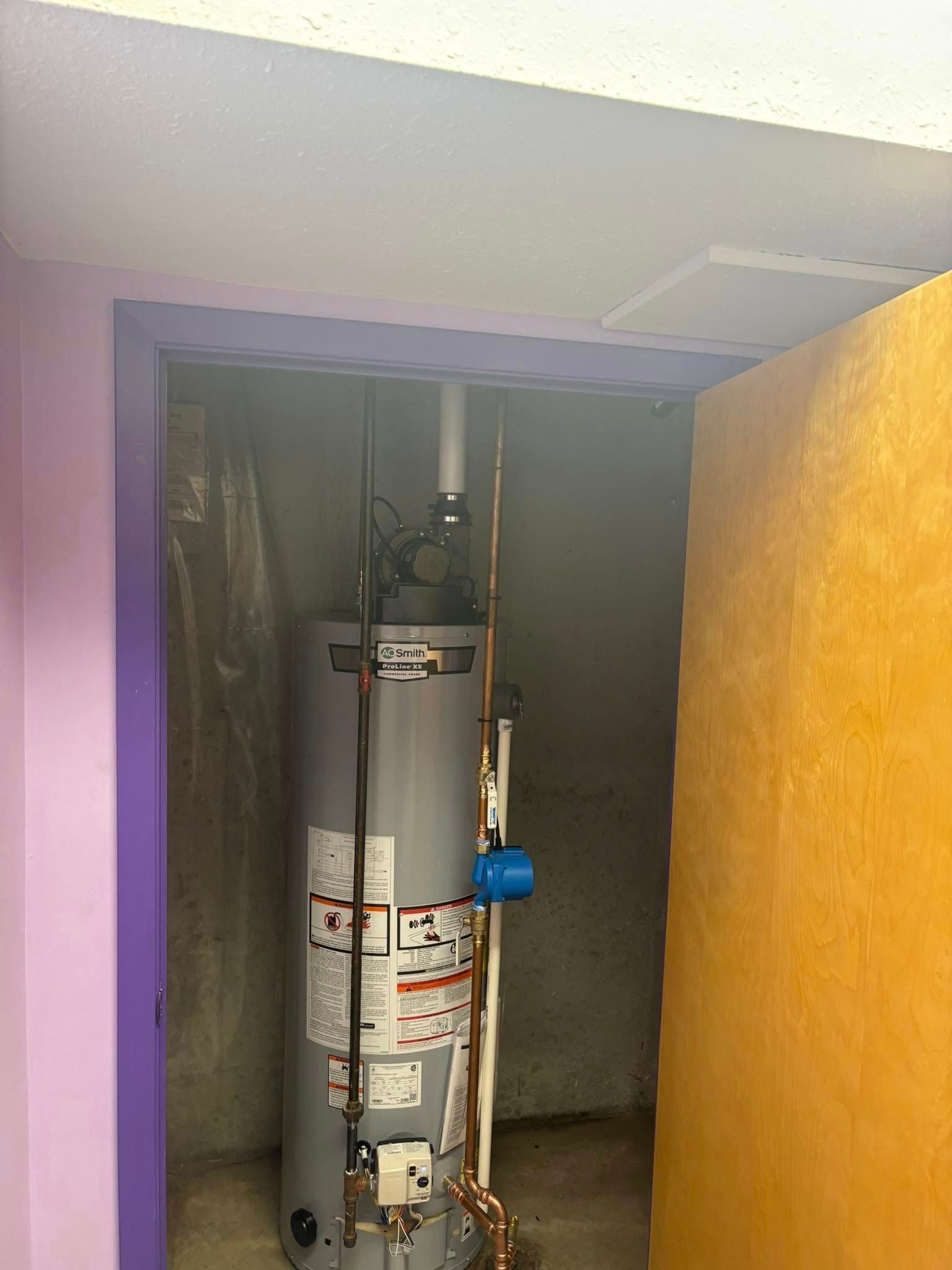 Lake Area Heating and Cooling LLC | A water heater is sitting in a closet next to a door.