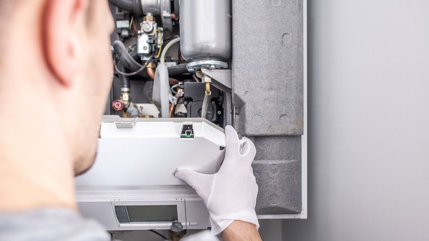 Lake Area Heating and Cooling LLC | A man is working on a wall mounted air conditioner.