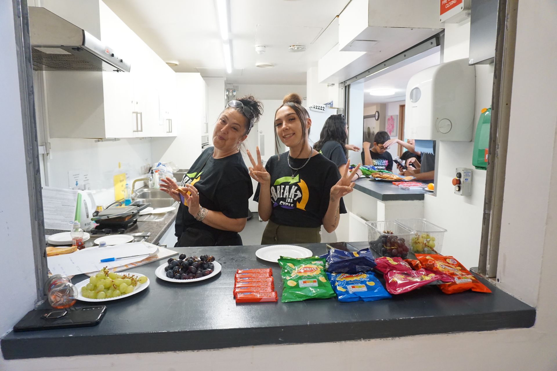 Two women are standing at a counter in a kitchen.
