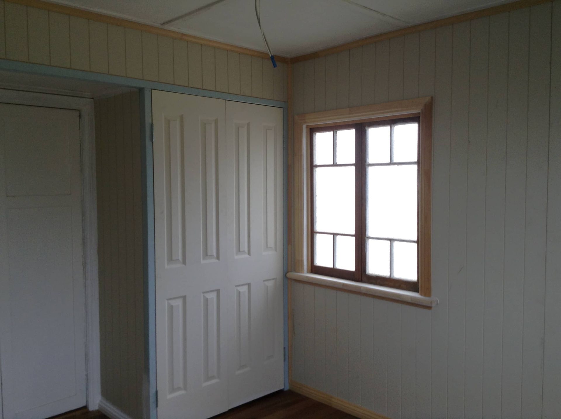 An Empty Room With White Walls and a Window — Gaspen Builders & Carpenters in Kirwan, QLD