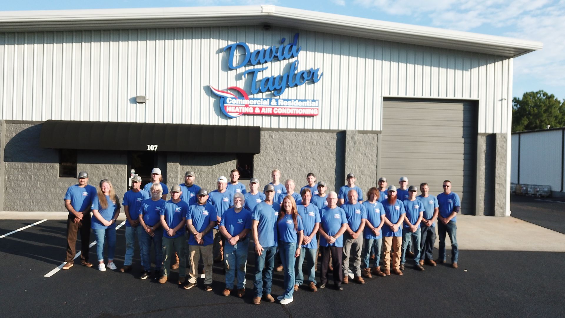 A group of people standing in front of a daniel taylor building