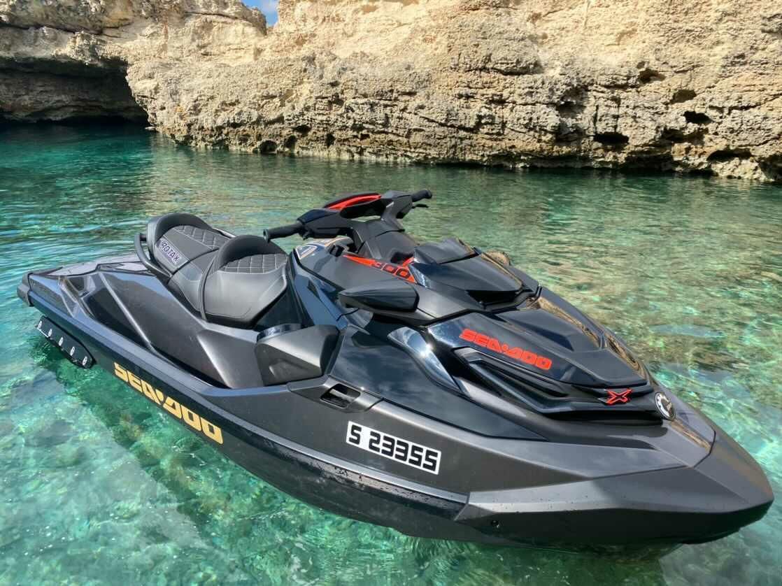 A black jet ski is floating on top of a body of water.