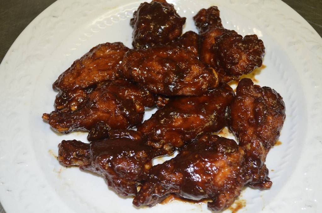 Plate of glazed chicken wings.