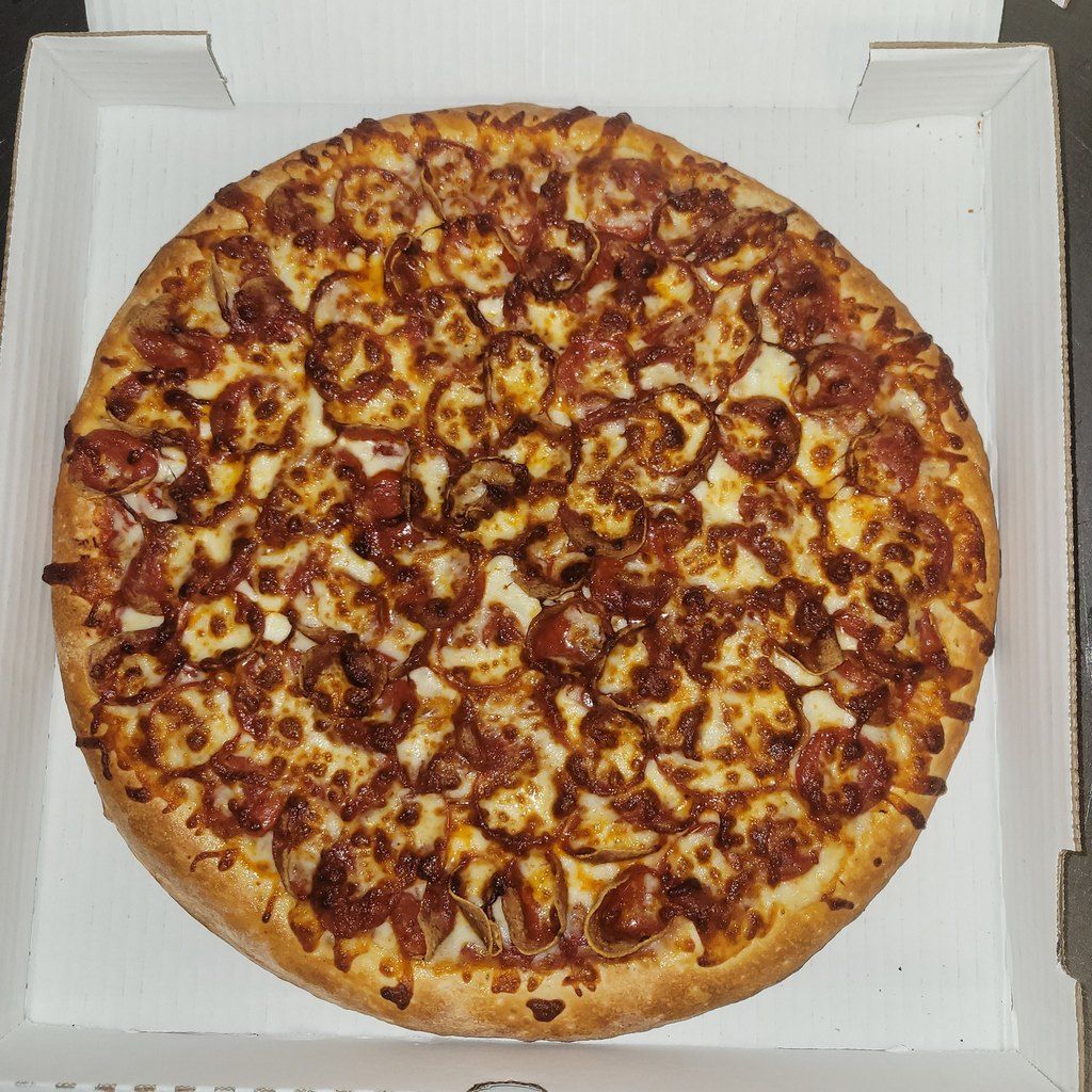 Pepperoni pizza in an open pizza box.