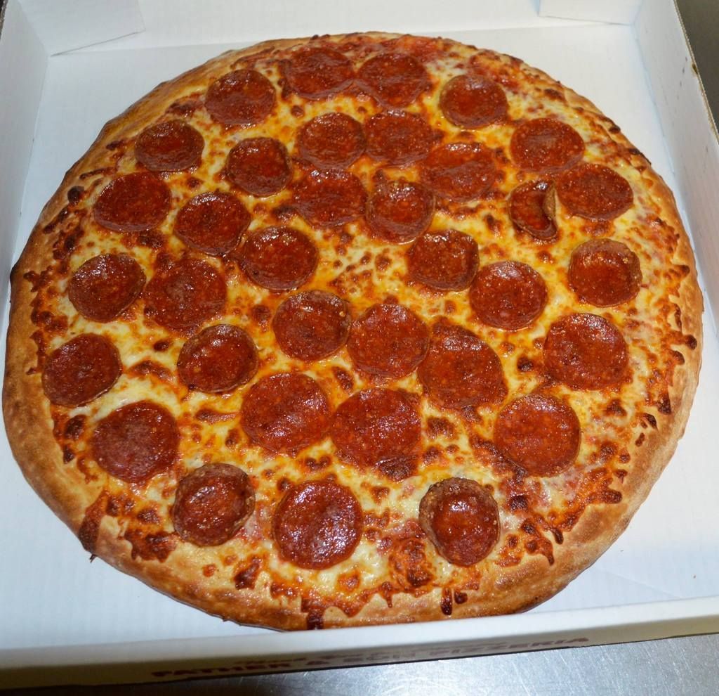 Pepperoni pizza in a cardboard box.