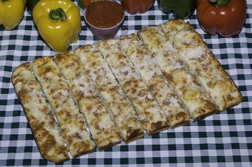 Cheesy bread on a checkered table cloth from Father & Son Pizzeria.