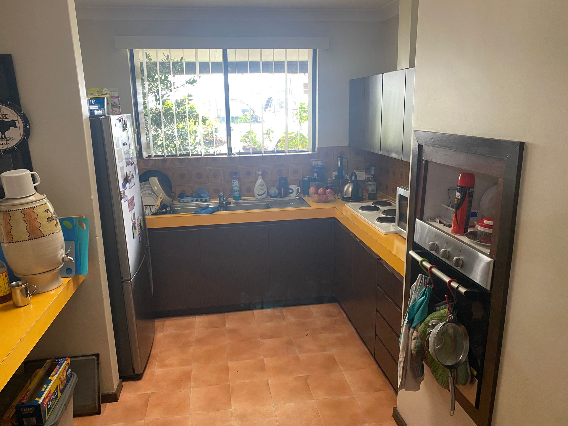 A kitchen with brown cabinets and a yellow counter top