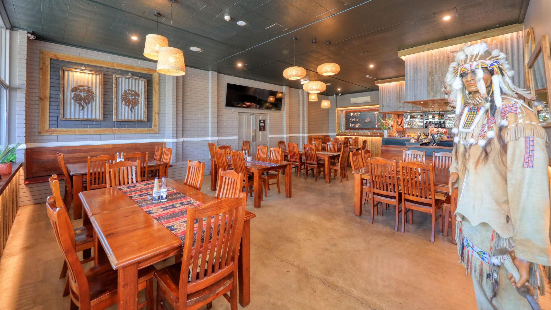 A large dining room with tables and chairs in a restaurant.