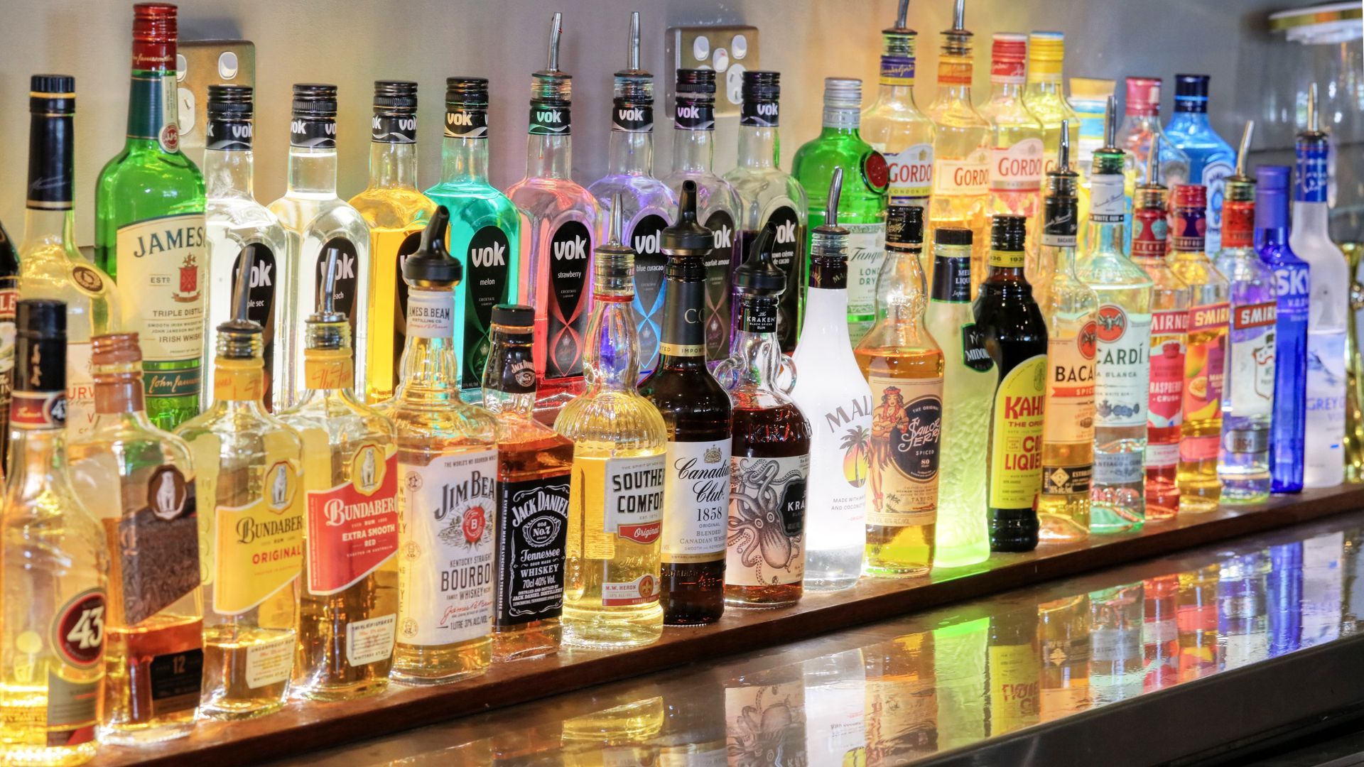 A bar filled with lots of bottles of liquor.