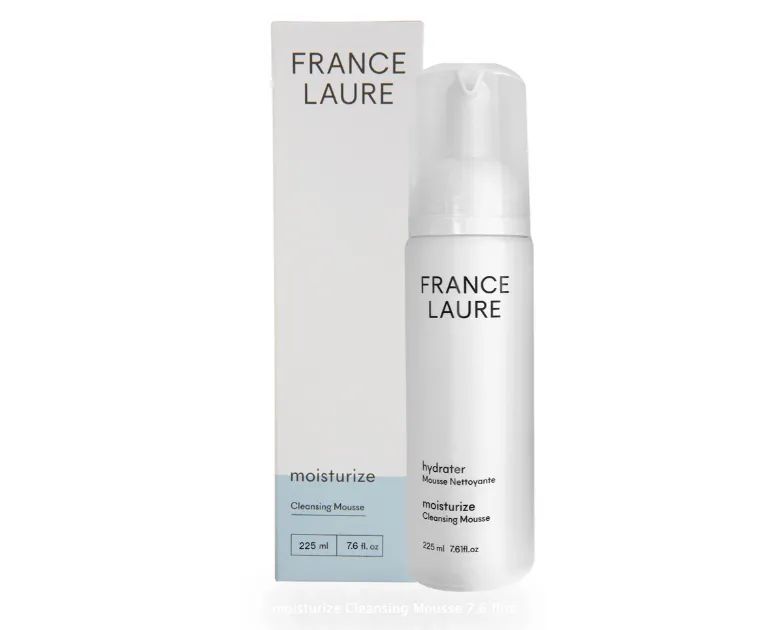 A bottle of france laure cleansing mousse next to its box