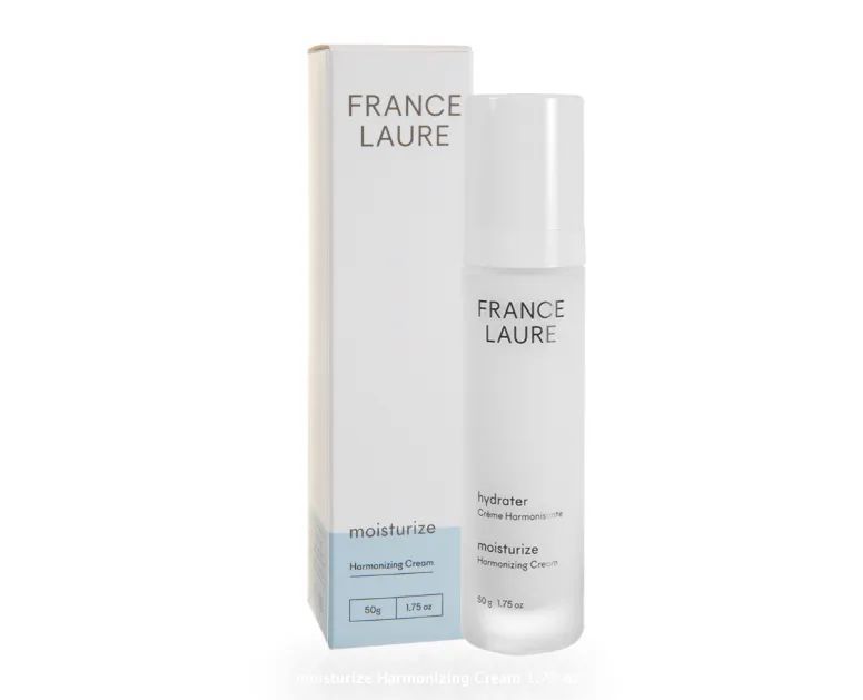 A bottle of france laure moisturizer next to its box