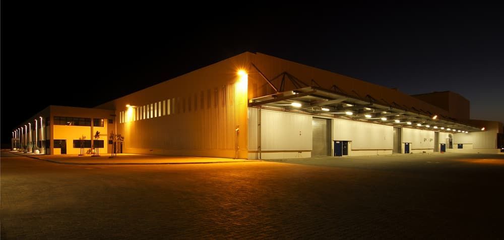 A Large Building is Lit Up at Night — Watkins Electrical In Pialba, QLD