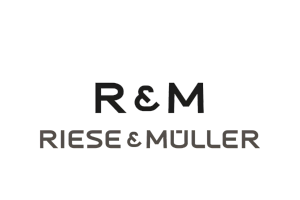 Logo van R&M Riese & Müller: zwarte letters "R&M" boven "RIESE & MÜLLER" in grijs.