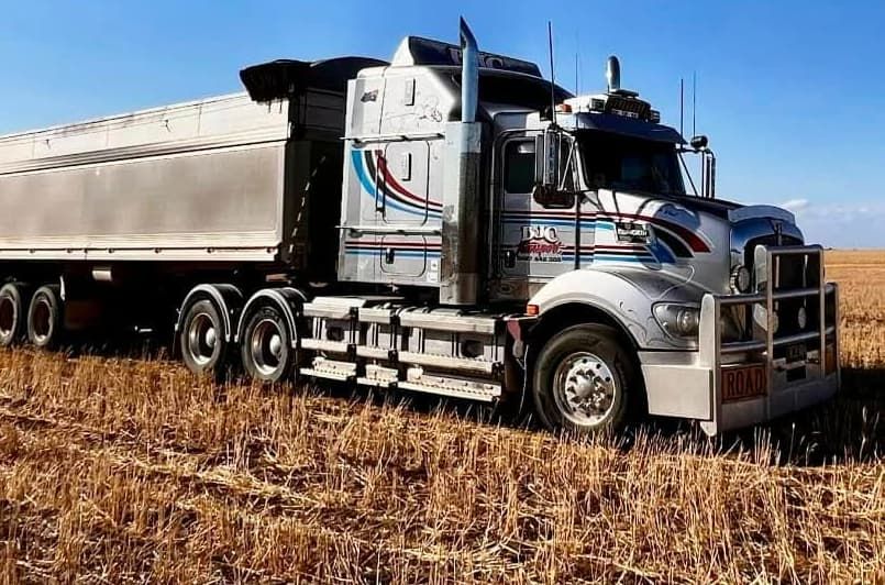A Semi Truck Is Parked In A Field Of Dry Grass — BJC Transport In Wondai, QLD