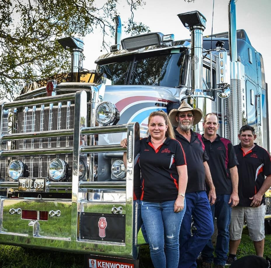 A Group Of People Standing In Front Of A Kenworth Truck — BJC Transport In Wondai, QLD