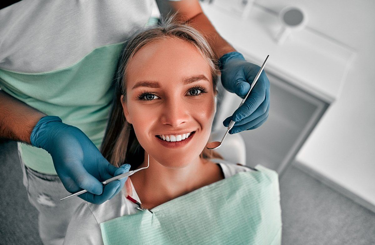 Woman Smiling During Dental Consultation — Coweta, OK — Allen S. Braumiller Jr. DDS, PC