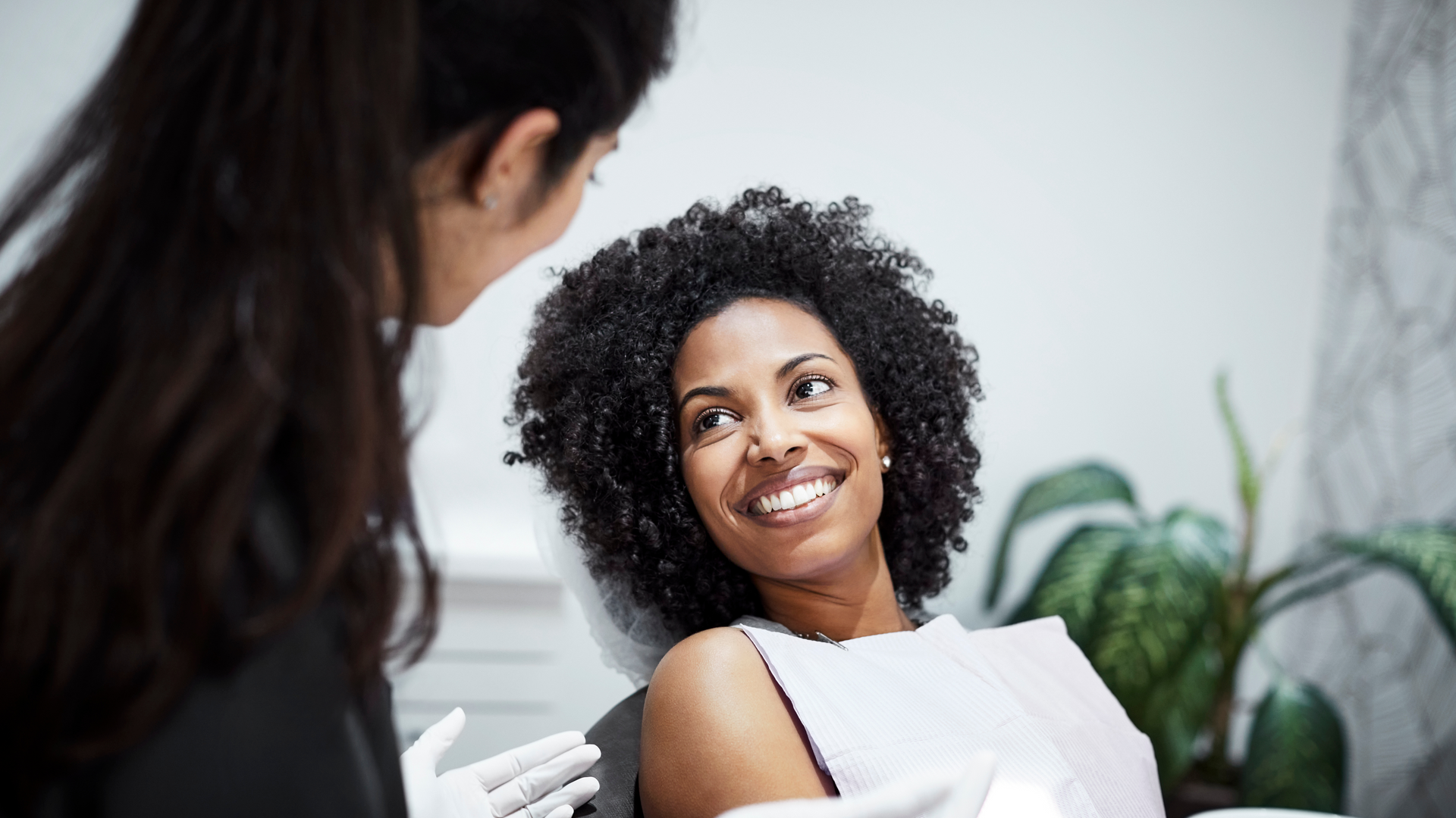 A client talking to their dentist. 