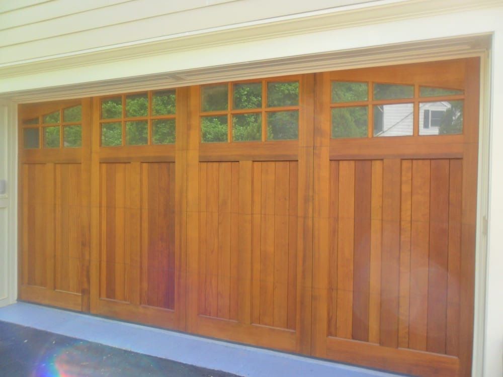 A wooden garage door with a lot of windows on it.