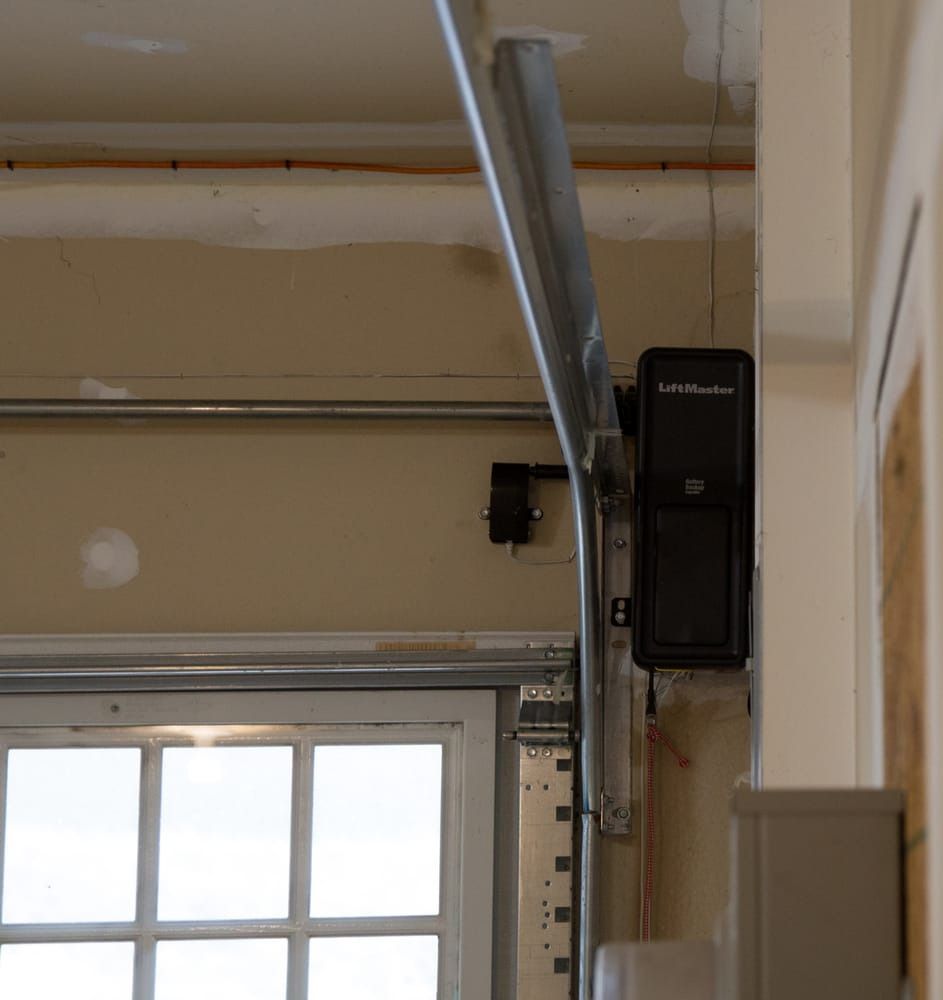 A close up of a garage door with a remote control attached to it.