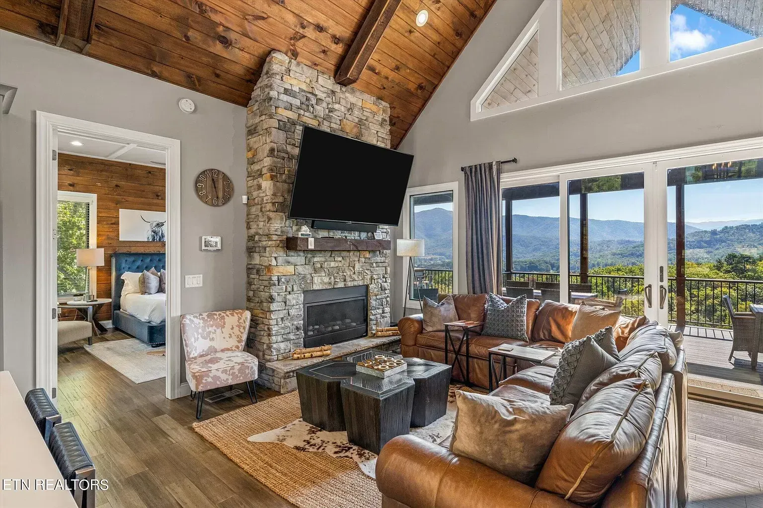 A living room with a couch , fireplace and television.