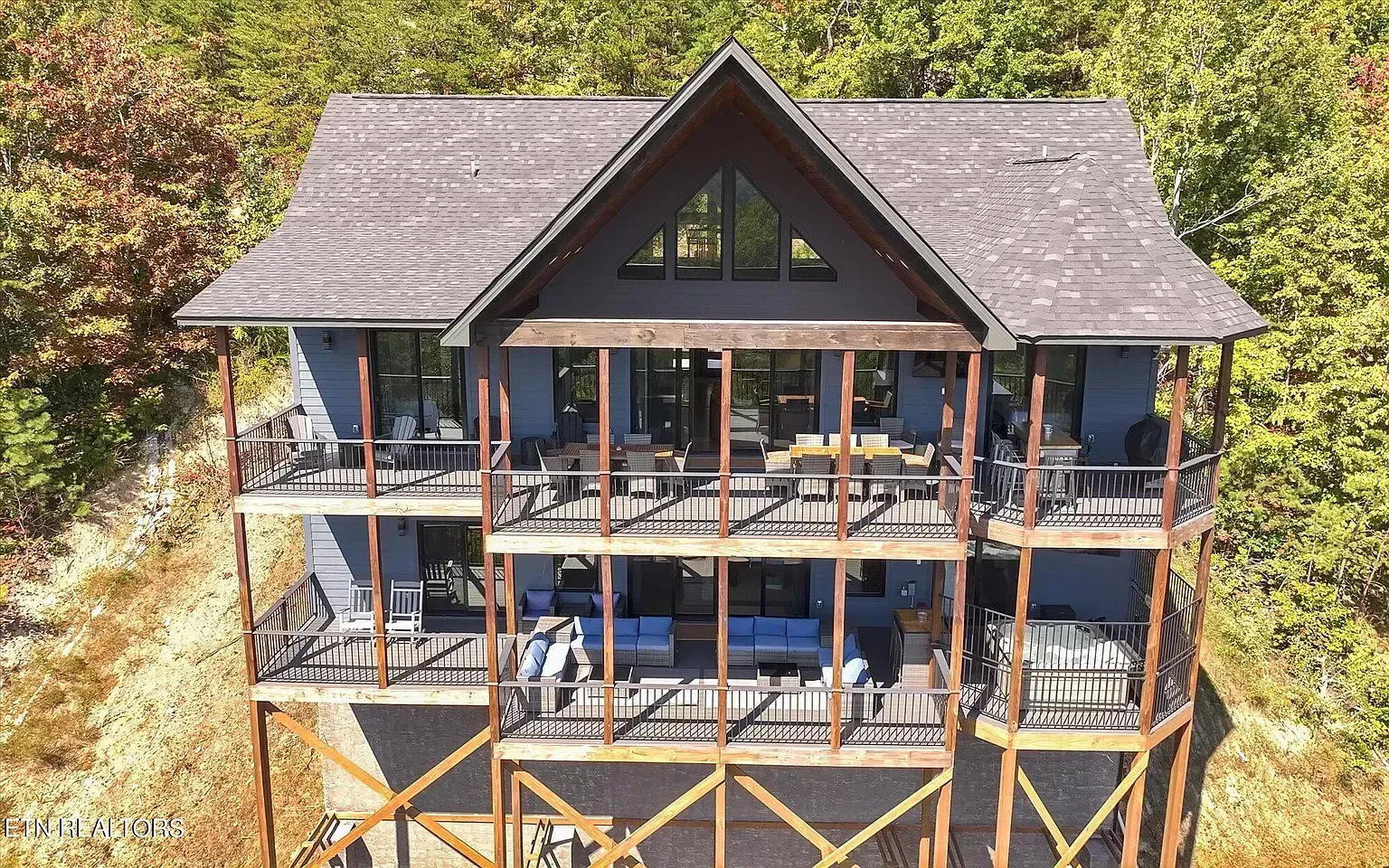 An aerial view of a large house surrounded by trees.