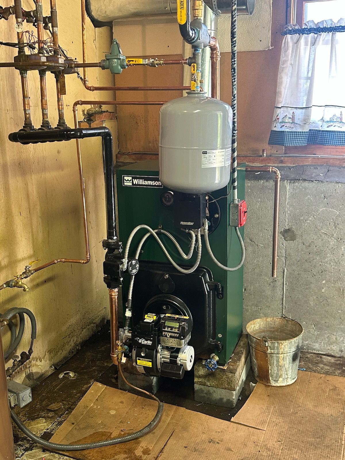 Black-and-white photo of an outdoor air conditioning unit against a wall