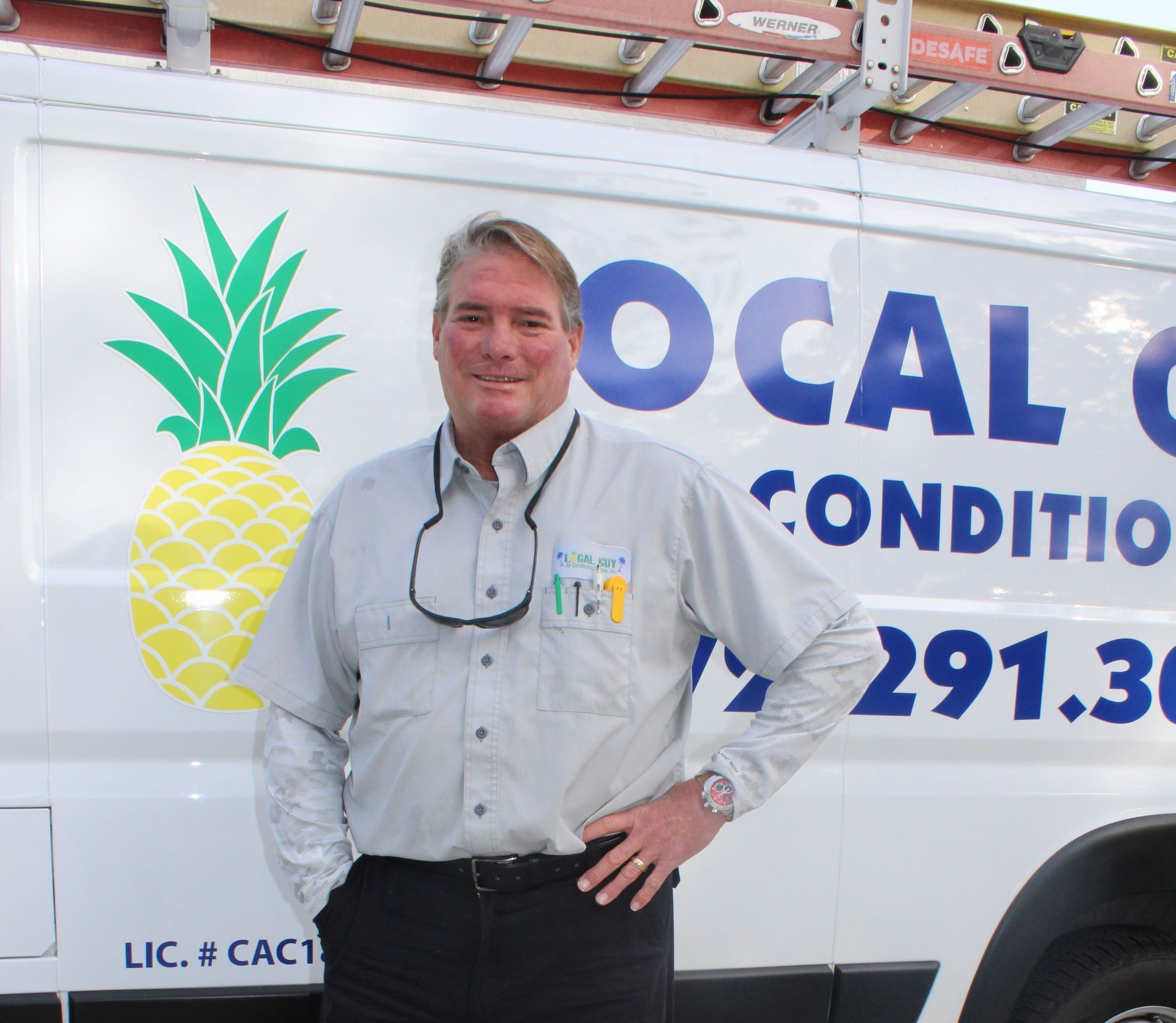 A Local Guy technician stands in front of a van that says local condition