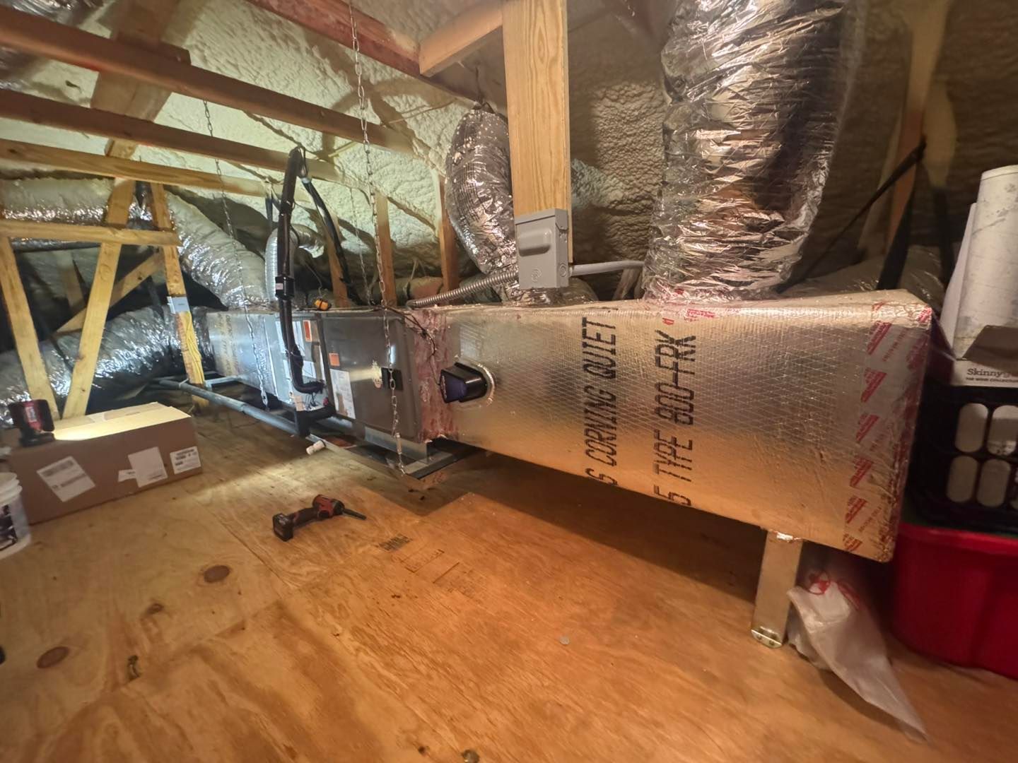 A room with a lot of ducts hanging from the ceiling.