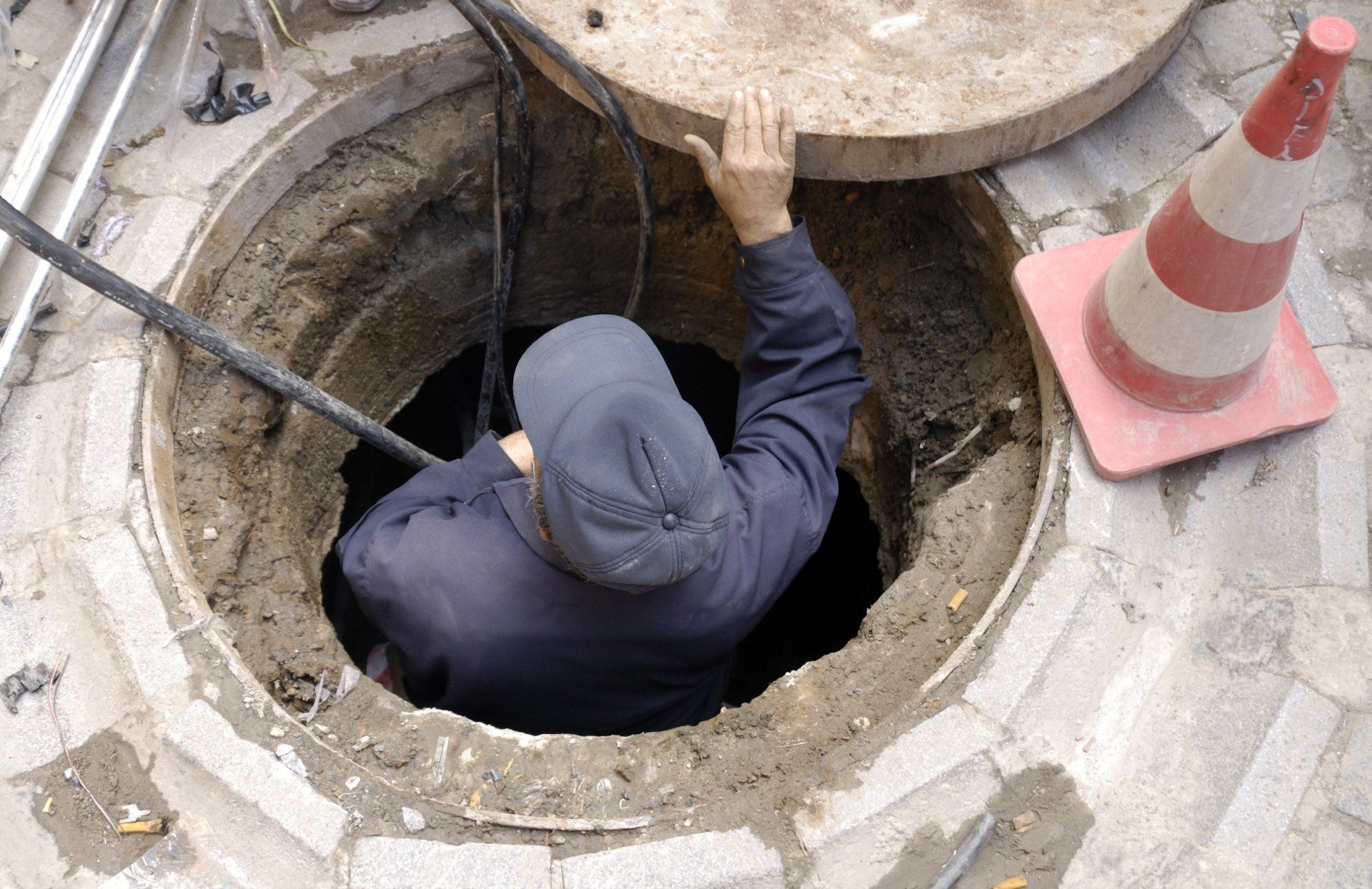 Plumber Going Down The Sewer Hole — Sierra Vista, AZ — Roto Rooter Sewer and Drains