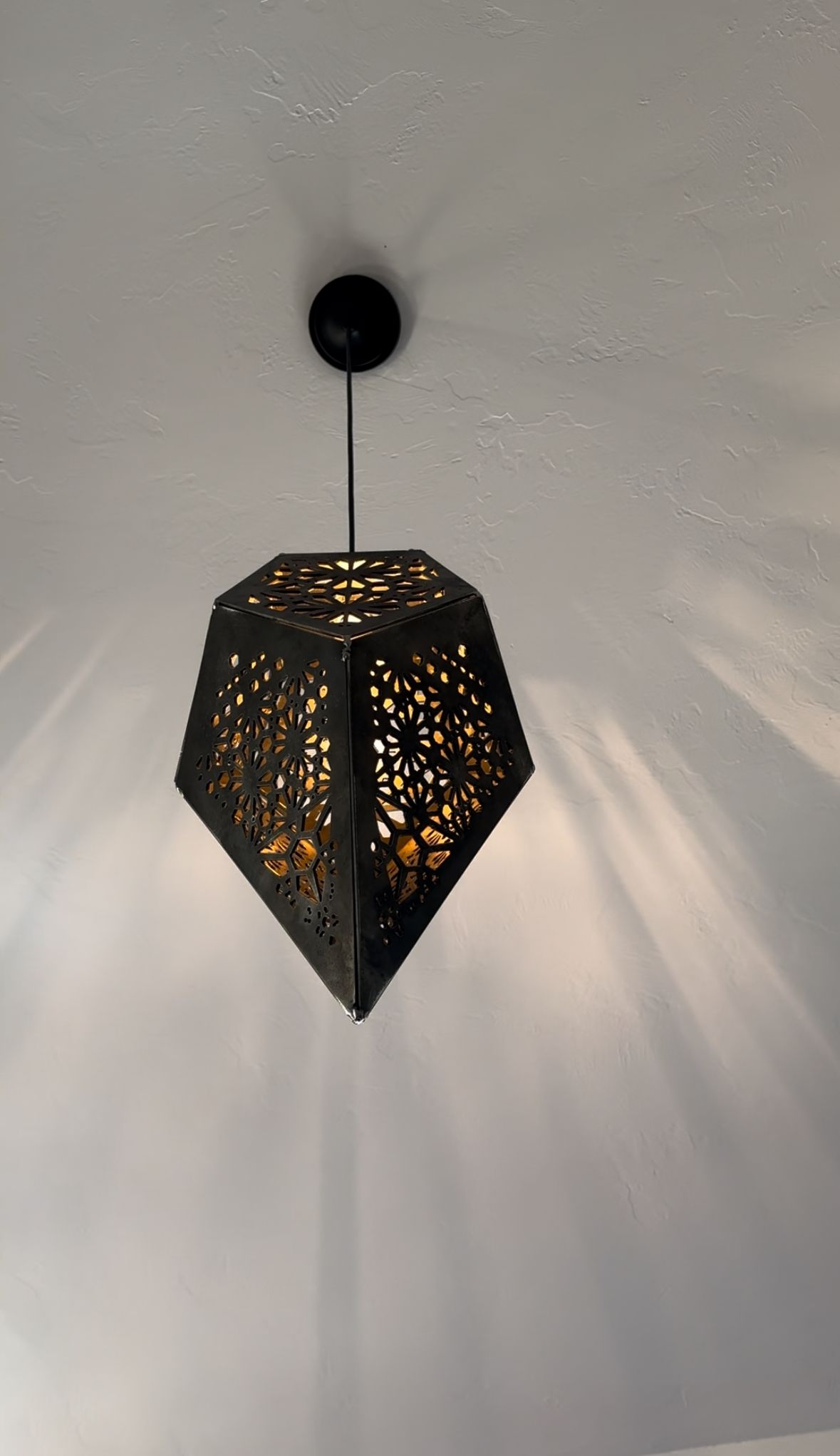 A black pendant light is hanging from the ceiling.