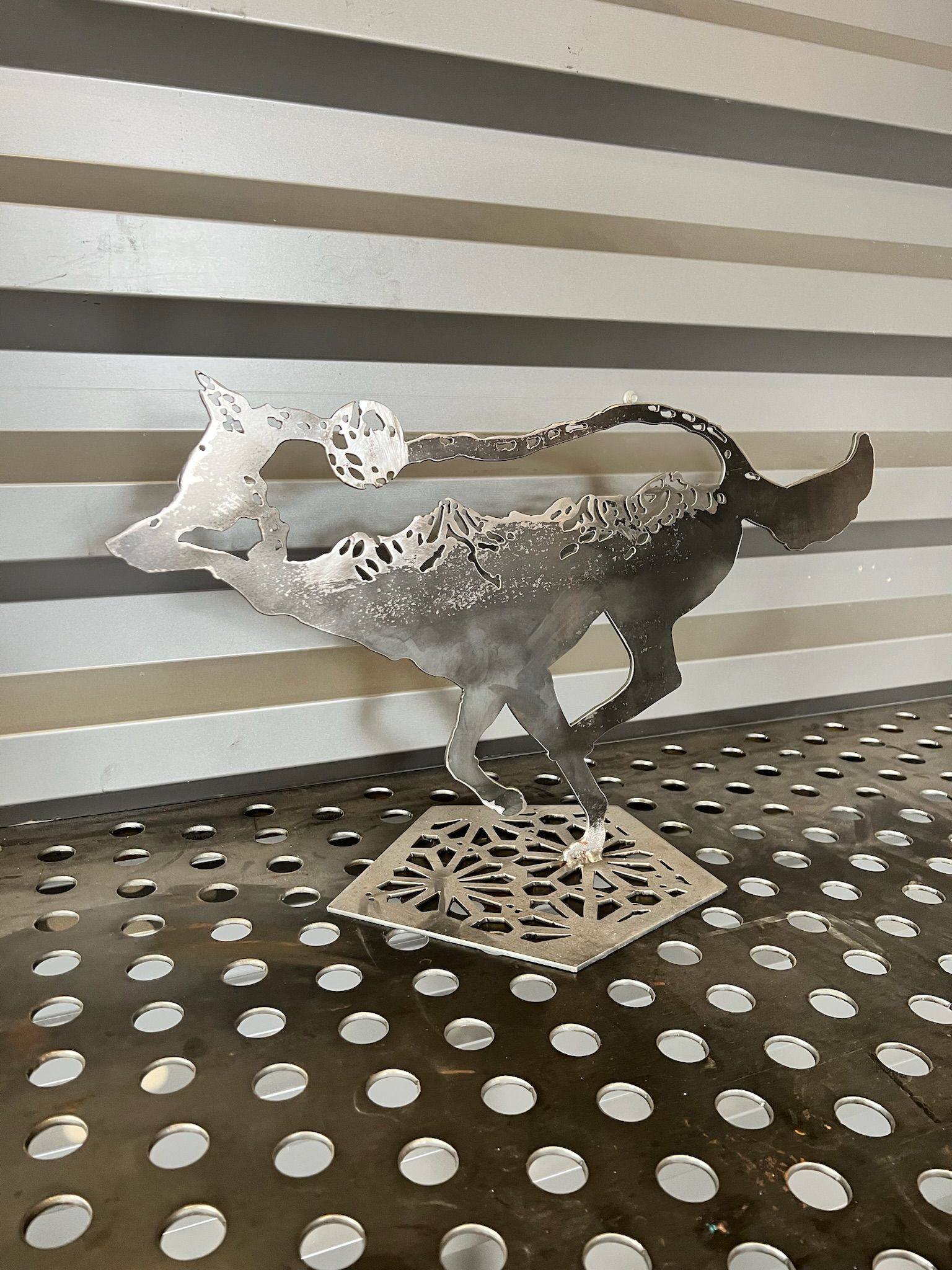 A statue of a dragon is sitting on a table with polka dots.