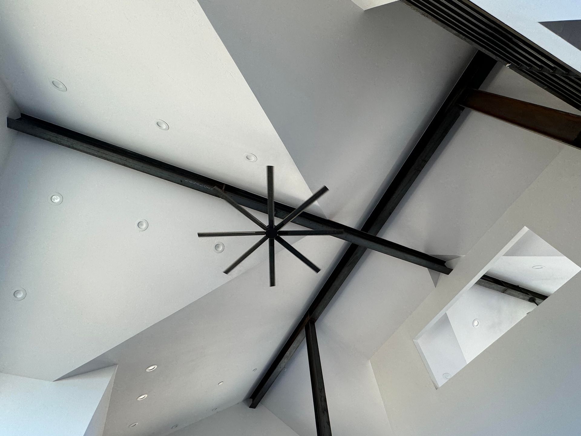 A ceiling fan is hanging from the ceiling of a building