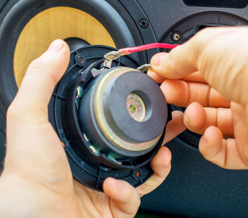 Male Hand Connecting Professional Studio Monitor Speaker — Kennedy Amplifier Hire Service In Mackay QLD