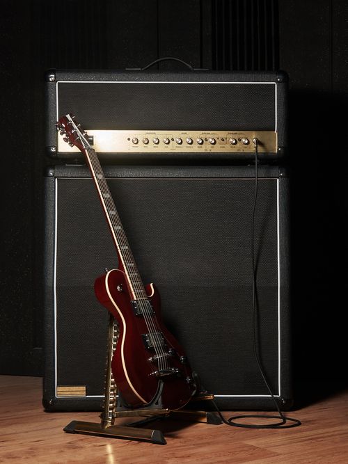 Red Electric Guitar And Classic Amplifier On A Dark Background — Kennedy Amplifier Hire Service In Mackay QLD