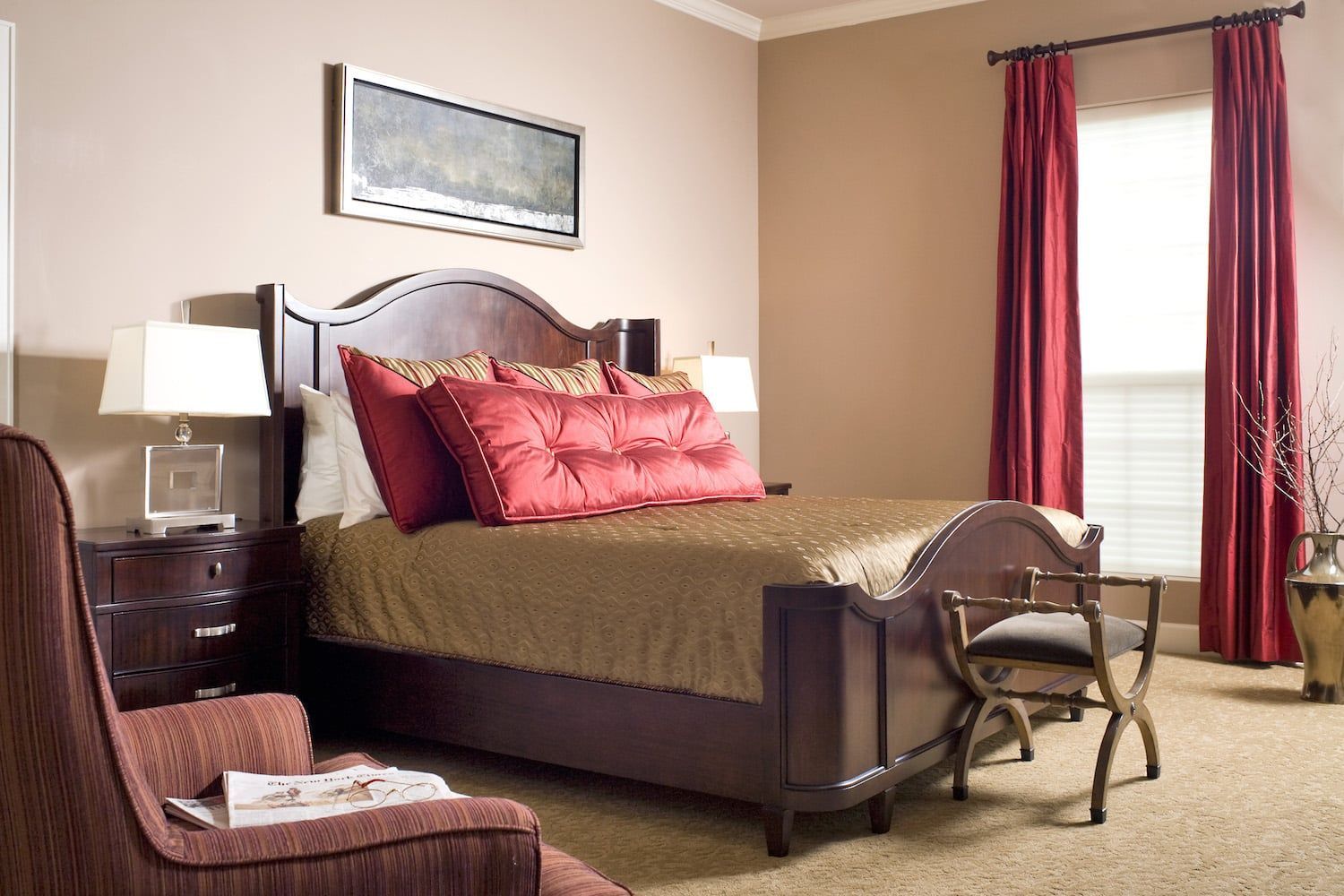 A bedroom with a large bed and red curtains